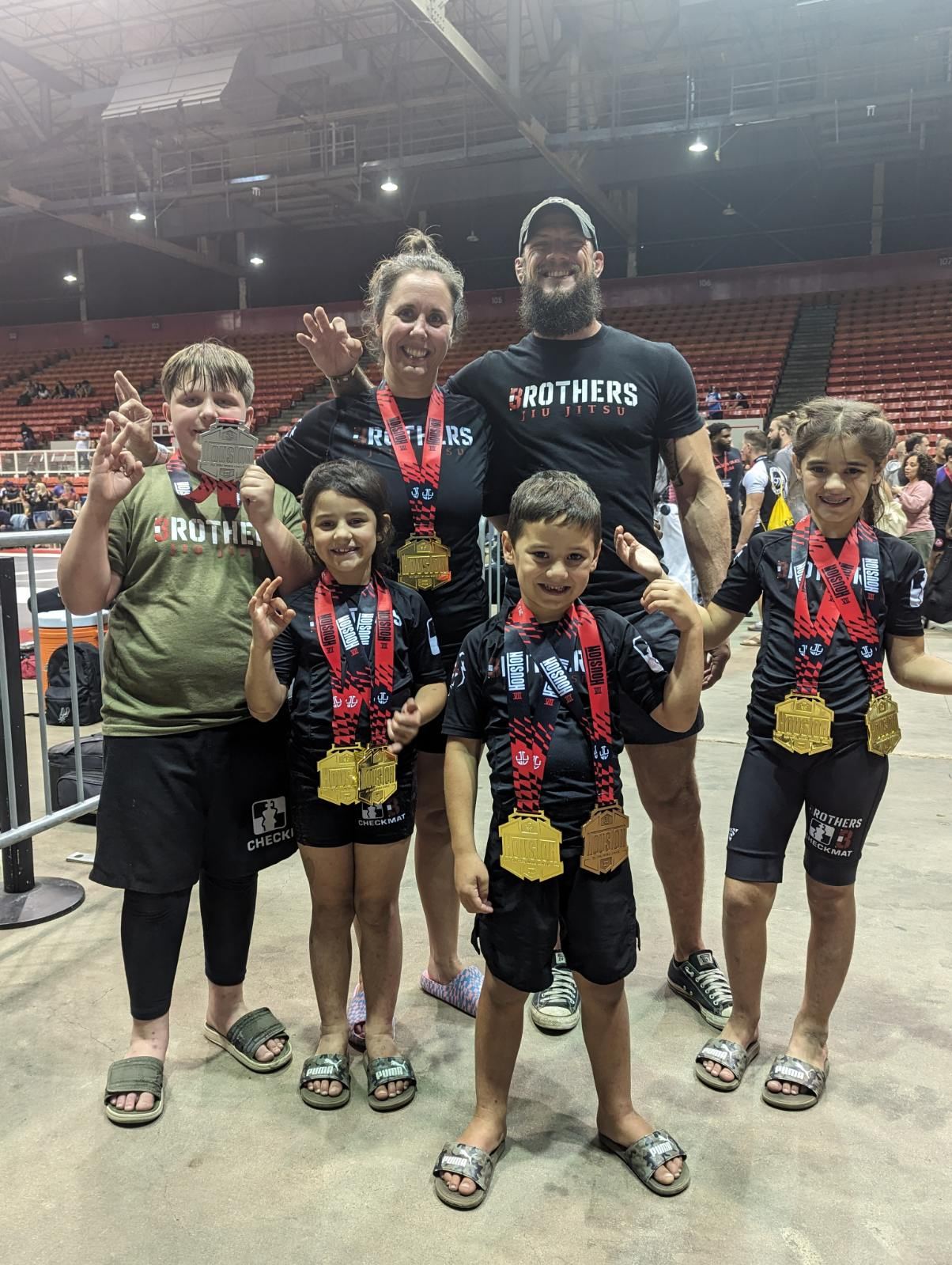 Three Brothers Jiu Jitsu family with competition medals